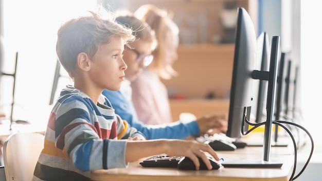 elementary school science classroom smart little schoolchildren sitting in row and work on personal