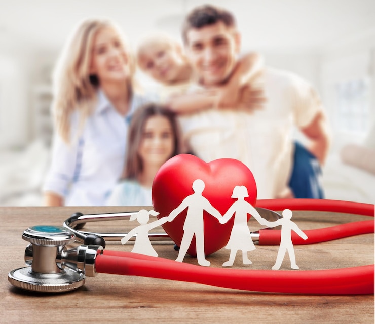 Fotoğraf family cut-out and stethoscope on wooden desk, medical insurance concept