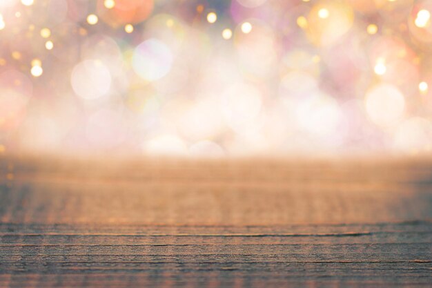 Festive wooden background with defocused shiny bokeh lights