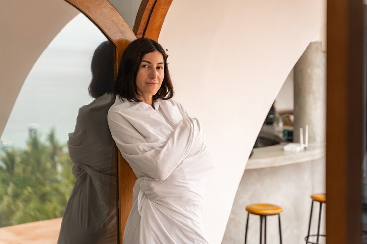 Fotoğraf front view of a smiling beautiful woman tourist wrapped in a sheet looking forward