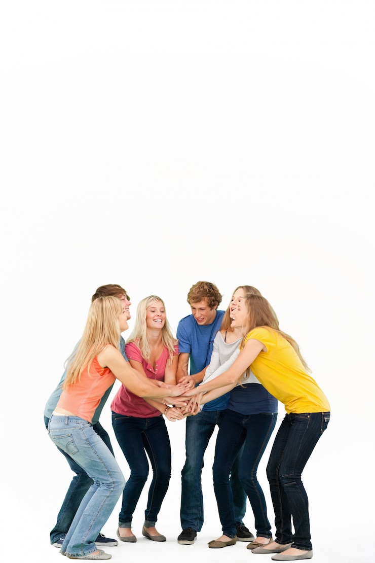 Fotoğraf group of friends about to cheer with their hands stacked smiling as they look at one another
