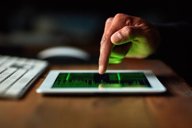 Hacker man hands and tablet screen for software data crack code or password and dark room in cybersecurity crime Online cyber thief and coding application of person hacking digital technology app