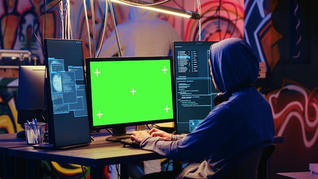 hacker uses green screen pc to code