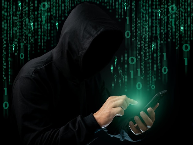 Hackers work on phone in the dark The concept of information security in the Internet network and information espionage Virus attack Hacker attack
