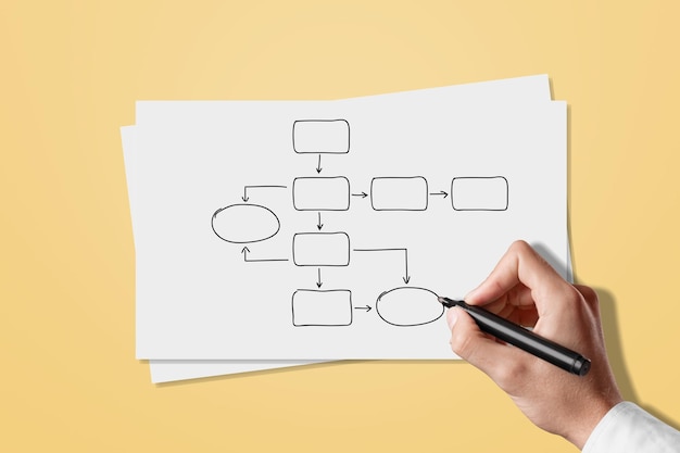 Hand drawing a family tree on a sheet of paper on a desk
