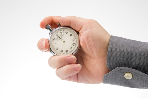 hand with a mechanical analog stopwatch on a white background time part precision measurement of the speed interval