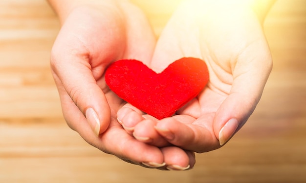 Hands holding red heart
