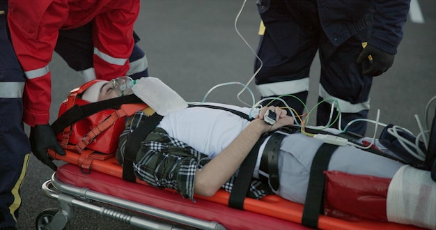 Healthcare paramedic and help patient in road on scene for emergency rescue and support Emt team people and stretcher for injured person on accident for medical service care and first aid