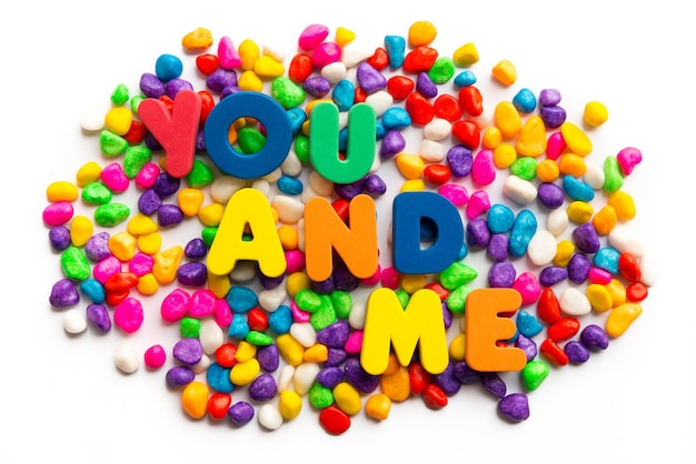High angle view of colorful candies with text over white background