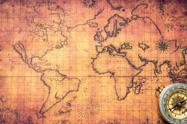 High angle view of navigational compass on old map