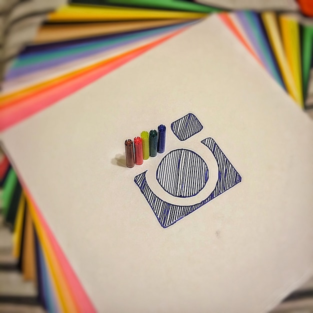 High angle view of pen top by drawing in paper