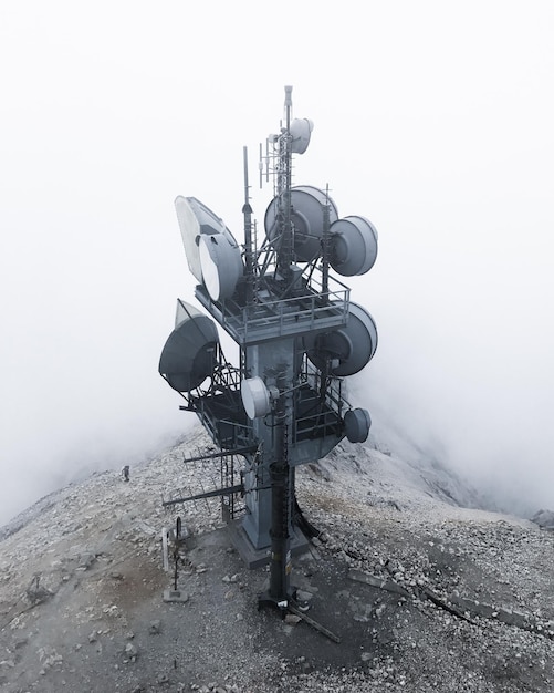 High angle view of telecommunications tower on mountain during foggy weather