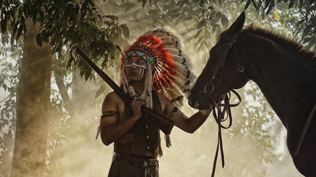 Hunter holding gun while standing by horse