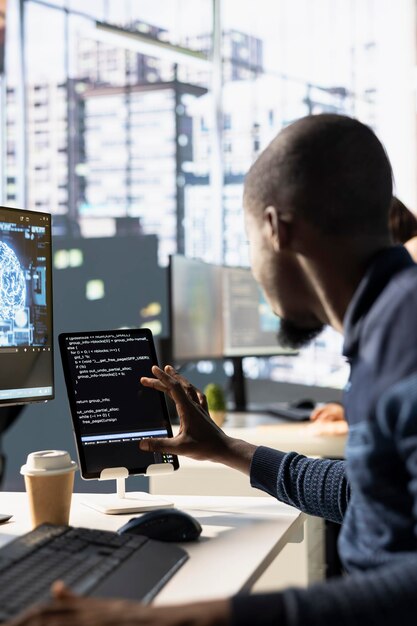 IT expert doing artificial intelligence programming using tablet