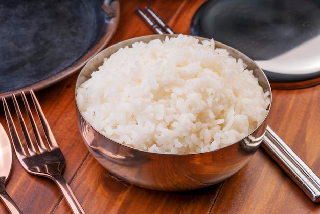 Korean steamed rice in silver cup ready to eat Korean style