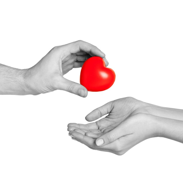 Fotoğraf love, relationship, charity and medicine concept - man hand giving red heart to woman