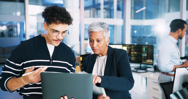 Man developer and mentor on laptop in office for programming coding training and server update People manager and help for testing pc IT intern and website application and troubleshooting system