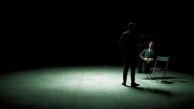 Man in suit in front of mirror stock footage man on stage with mirror puts on suit stage production