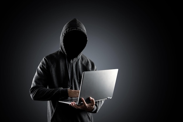 Man using mobile phone against black background