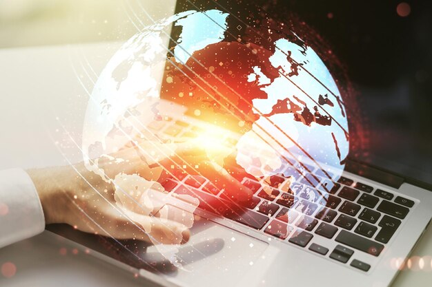 Multi exposure of abstract creative digital world map and hand typing on computer keyboard on background research and analytics concept