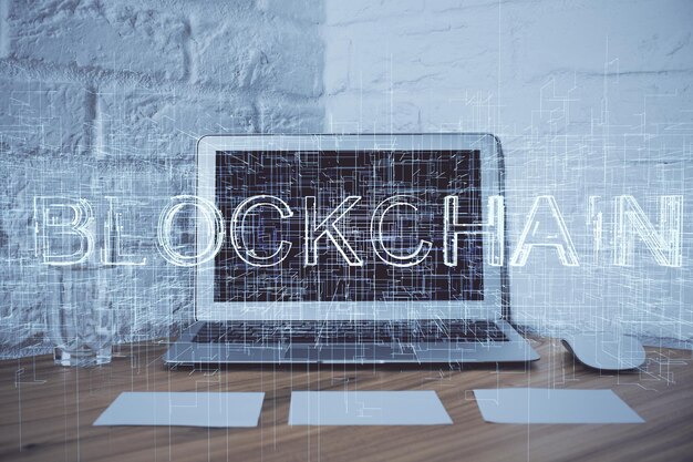 multi exposure of blockchain and crypto economy theme hologram and table with computer background concept of bitcoin cryptocurrency