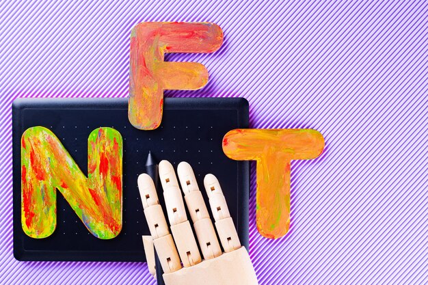 nft non-fungible token . artificial hand creates crypto art using a graphics tablet. gypsum copy of ancient sculpture and the inscription nft