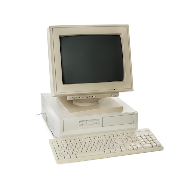 Old computer monitor system unit and keyboard on white background