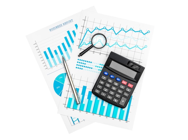 Paper financial graphs and charts with calculator magnifying glass and pen isolated on white
