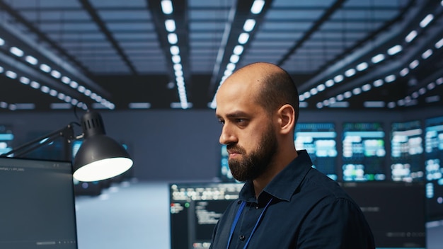 Programmer writing code working in network security data center