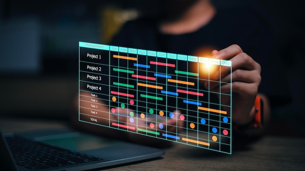 project manager and updating tasks and milestones progress planning with gantt chart scheduling interface for the company on virtual screen business project management system