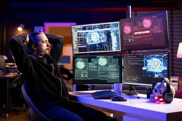 Rogue programmer at home coding on pc using ai to evade security with stealth malware hacker in