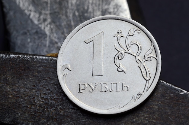 Russian coin with a face value of 1 ruble and an old working tool closeup translation of the text on the coin quot1 rublequot