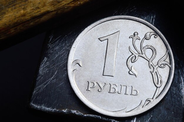 Russian coin with a face value of 1 ruble and an old working tool closeup translation of the text on the coin quot1 rublequot