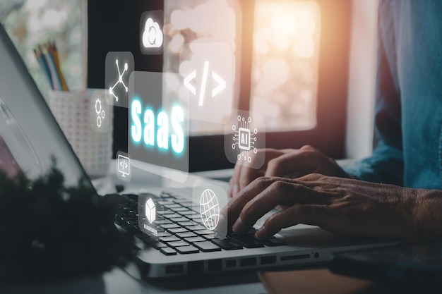 SaaS software as a service Businessman hand working on laptop to synchronize on SaaS host server to working on system for technology and business concept