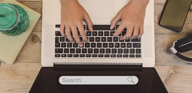 Searching data on internet concept working at laptop on desk finding information online search bar