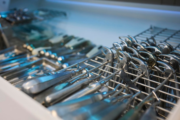 Shiny and polished cutlery resting in a tidy dishwasher basket ready for cleaning