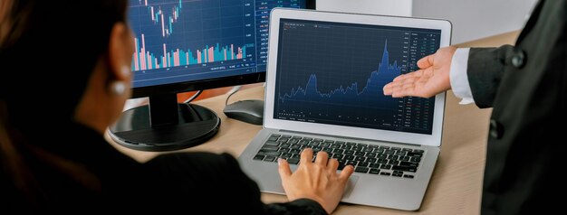 Skilled businessman analysis stock graph while pointing at display Burgeoning