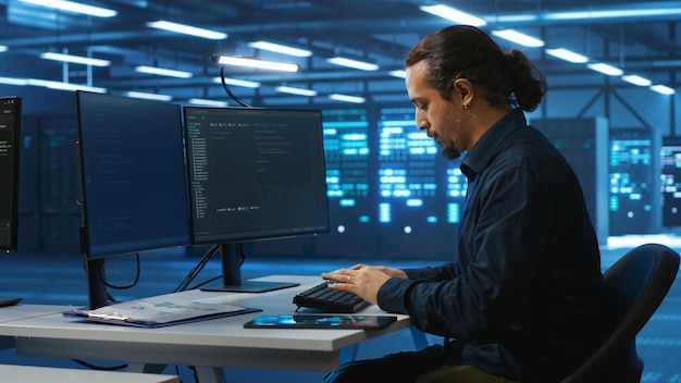 Specialist working in high tech facility doing system analysis coding