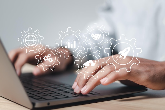 Startup business concept Businessman use laptop with rocket icons for fast start up business Plan work strategies and business success