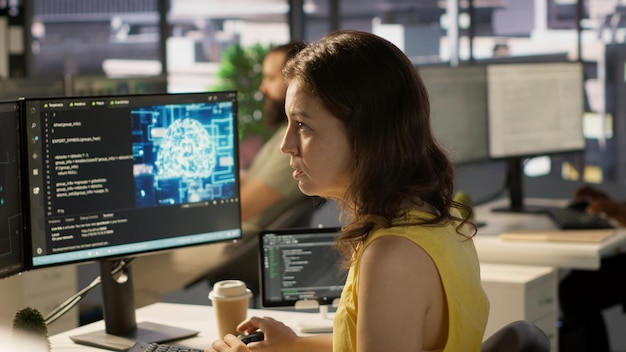 System administrator at work doing debugging of AI software using PC
