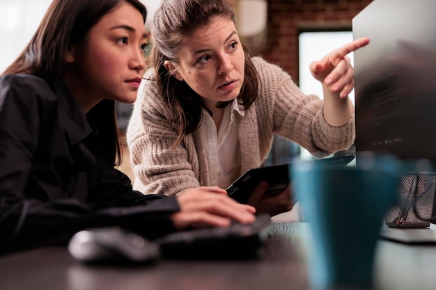 system engineers collaborating on coding project, discussing about programming algorithm for new cloud computing user interface. diverse team of software developers running database system code.