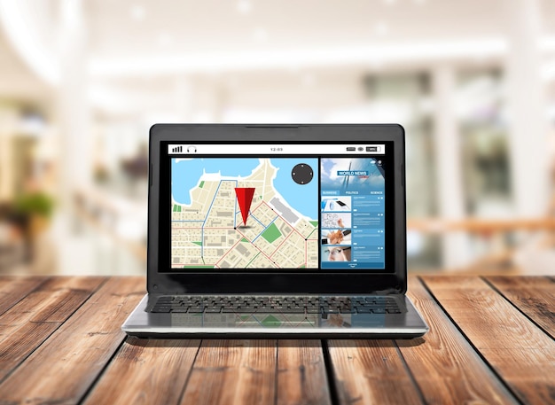 technology, navigation and advertisement concept - laptop computer with gps navigator map on screen