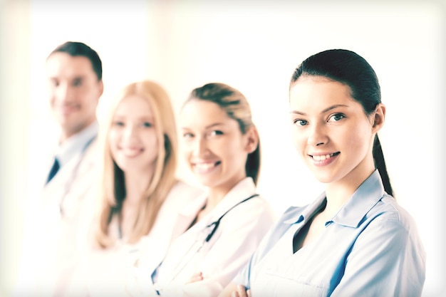 Tıp grubunun önünde çekici kadın doktor veya hemşire