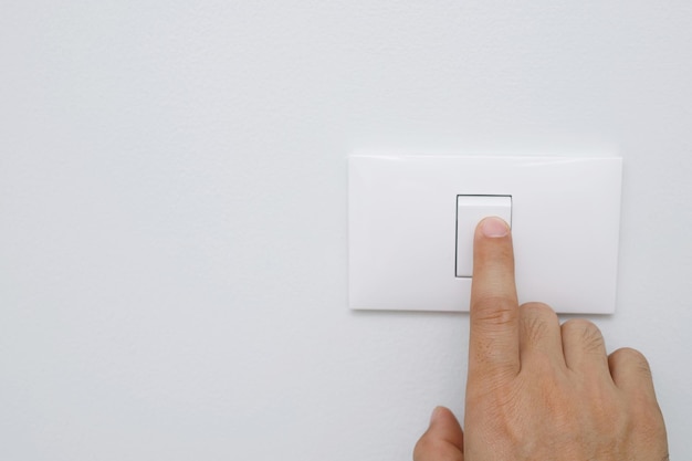 turn off the light close up female hand is closing the power switch save energy reduce global warmingx9