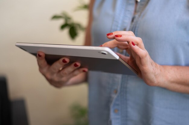 Unrecognizable MiddleAged Woman Holding A Tablet Concept Of Older Women And New Technologies