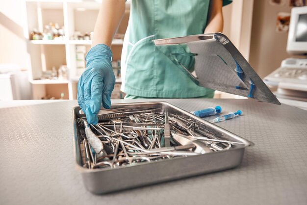 Vet tool kit photo of vet hands in protective gloves taking the necessary tool that