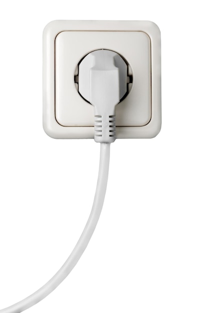 White electrical plug in the electric socket on a wall
