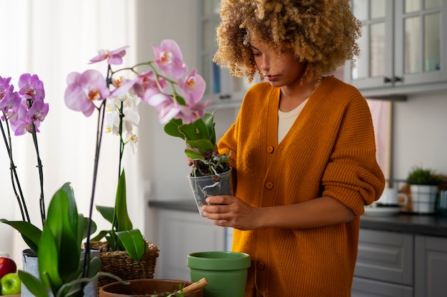 woman decorating her home with orchids