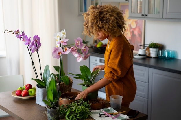 woman decorating her home with orchids