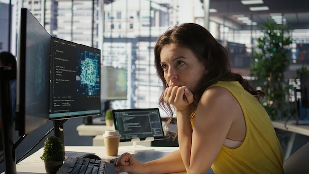Woman in office using laptop to steal company secrets